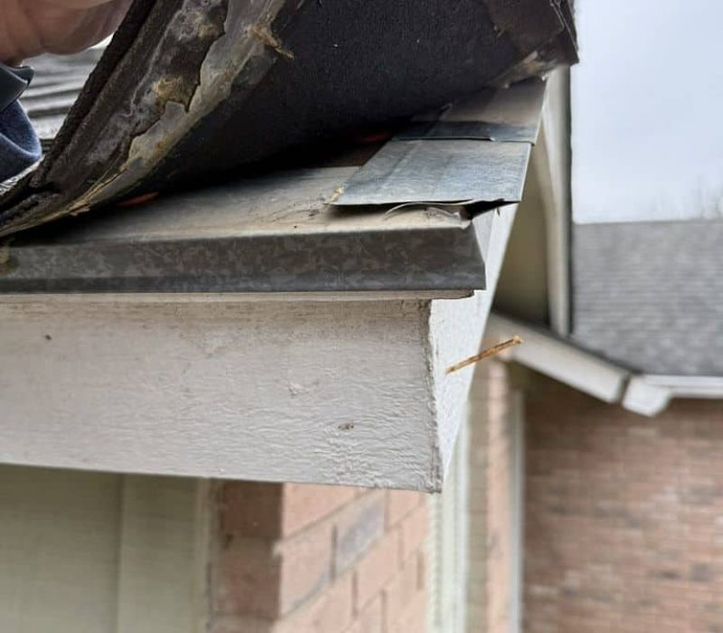 Roofing contractor inspecting storm damage for insurance purposes