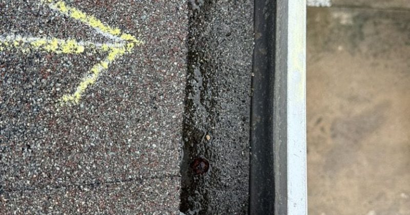 Professional roofer marking roof during inspection