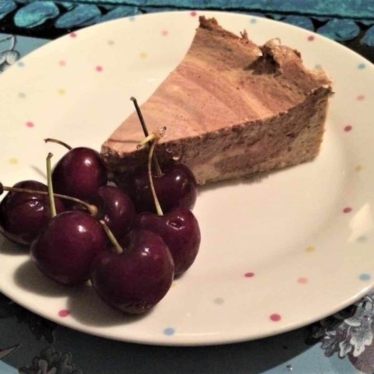 chocolate and coffee cheesecake served with fresh cherries on slimming world