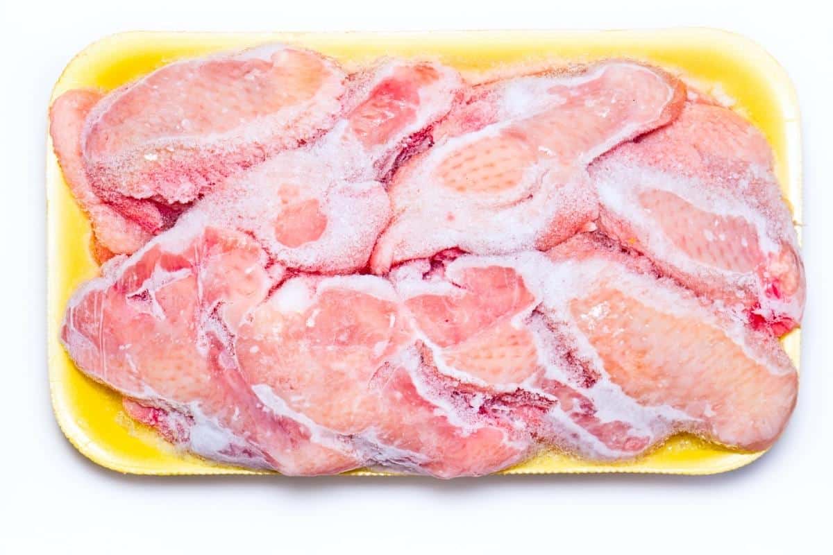 frozen chicken in a yellow tray