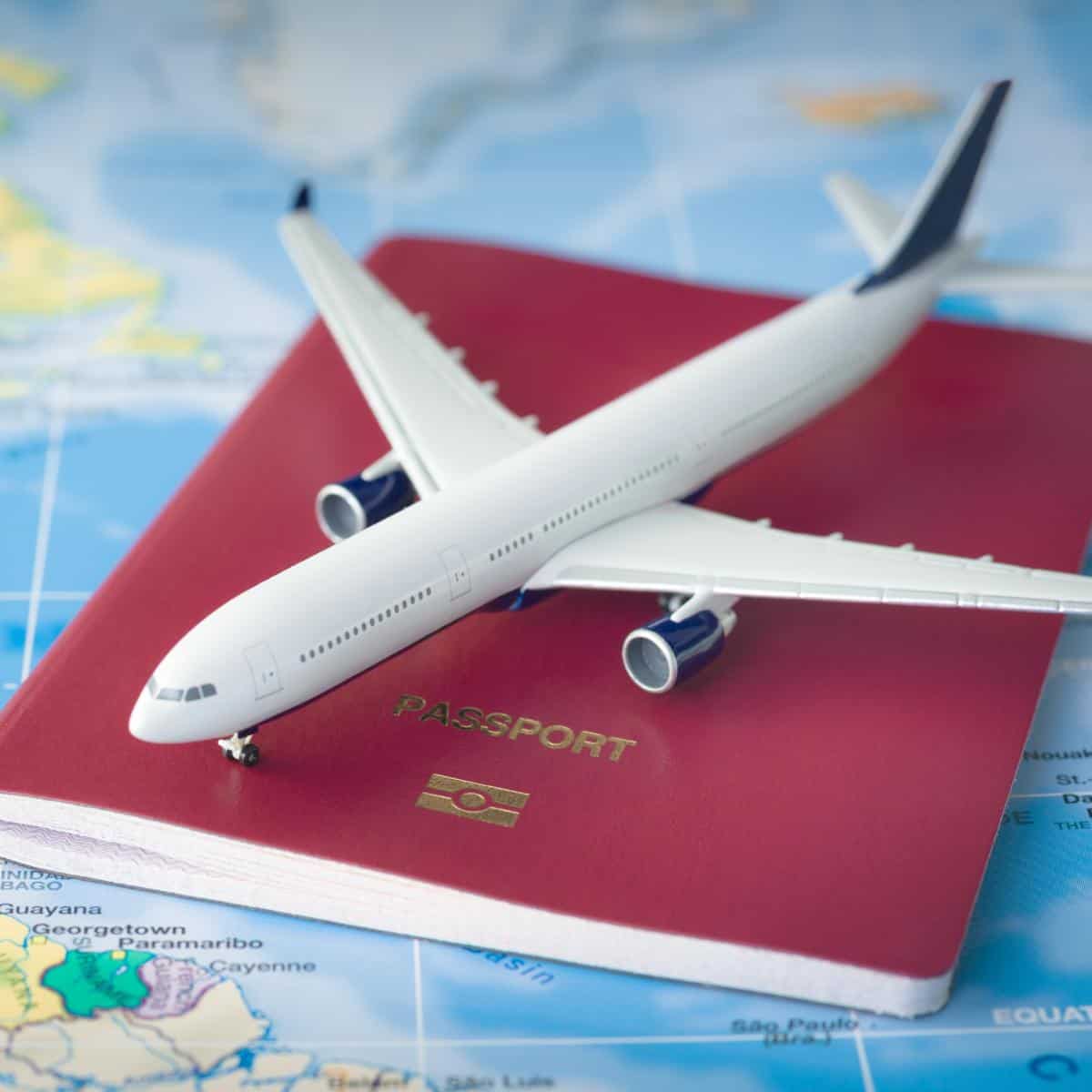 travel picture of toy plane and passport on a map