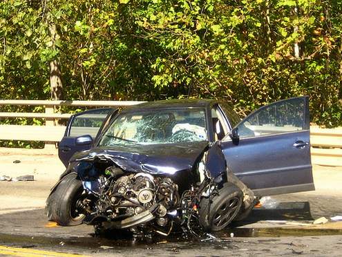 Front end damage to car after crash in the street