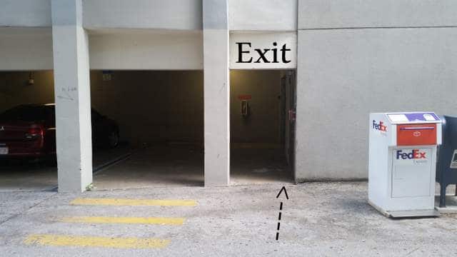 Office building asphalt next to parking lot.