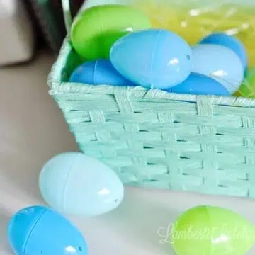 blue and green plastic easter eggs in a blue easter basket.