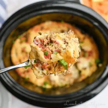 breakfast casserole on a spoon above a crock pot.