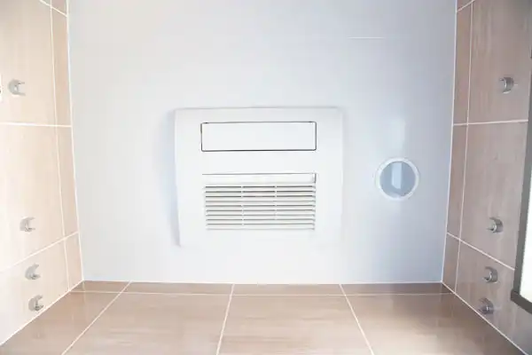 Ceiling view of a modern bathroom in Fairfax VA, featuring multiple wall-mounted shower jets, a central ventilation or heating unit, and space ideal for dehumidifier installation.