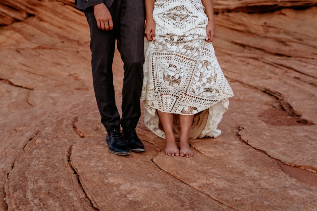 Bare feet under bride's lace Bohemian Rue De Seine elopement dress
