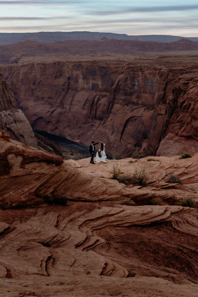 Elopement couple dancing at the edge of Horseshoe Bend