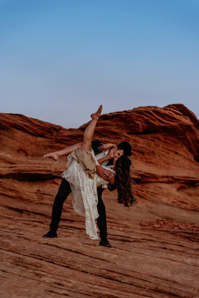 Bride points her toes high into the air as groom dips her in Page, Arizona elopement