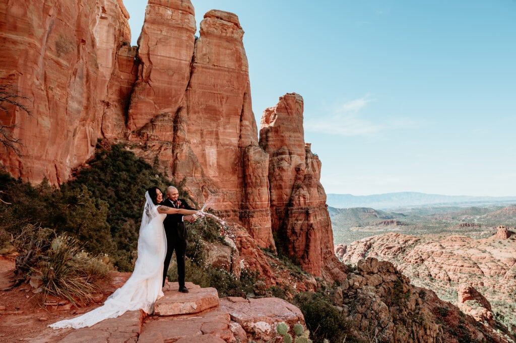 Champagne pop at the end of Sedona elopement