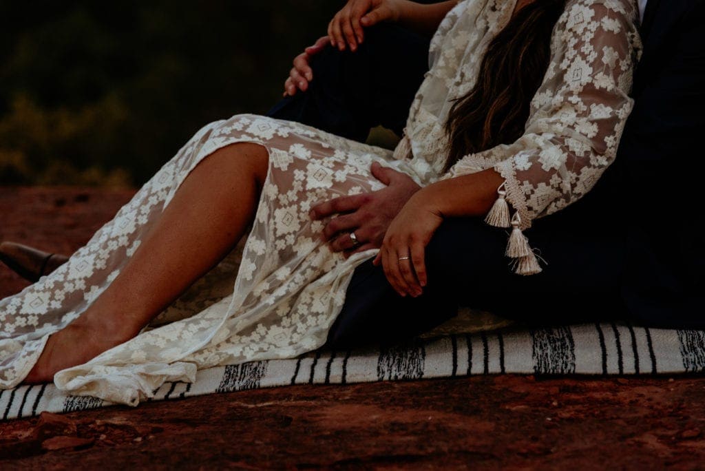 Couple snuggles to enjoy the last of the sunlight before heading down the mountain