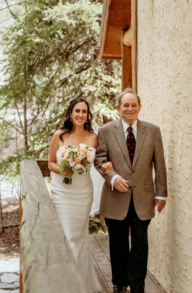 Bride and groom walking down the isle during Lake City wedding