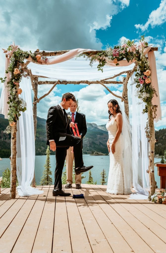 Benton performs the traditional breaking of the glass during their Lake City elopement