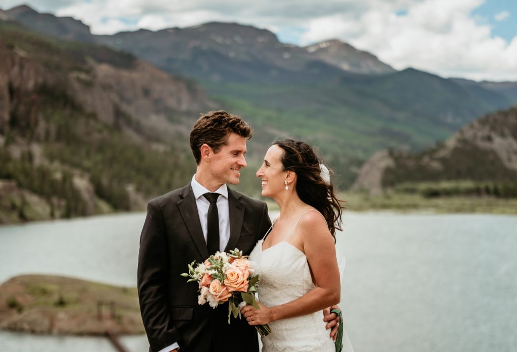 Bride and groom with Lake San Cristobal and mountains in the background