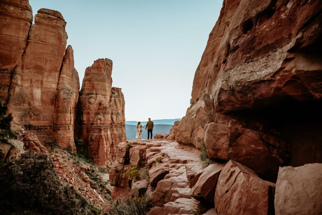 Couple holding hands after hiking Cathedral rock in Sedona Arizona