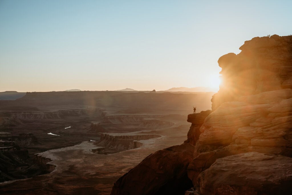 Hiker standing on a canyon ledge at Canyonlands National Park in Moab