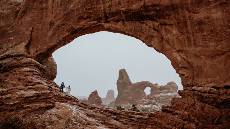 Couple inside north arch during their Moab elopement