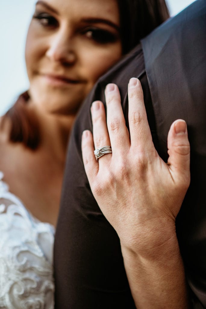 Bride's ring as she holds her new husband's arm