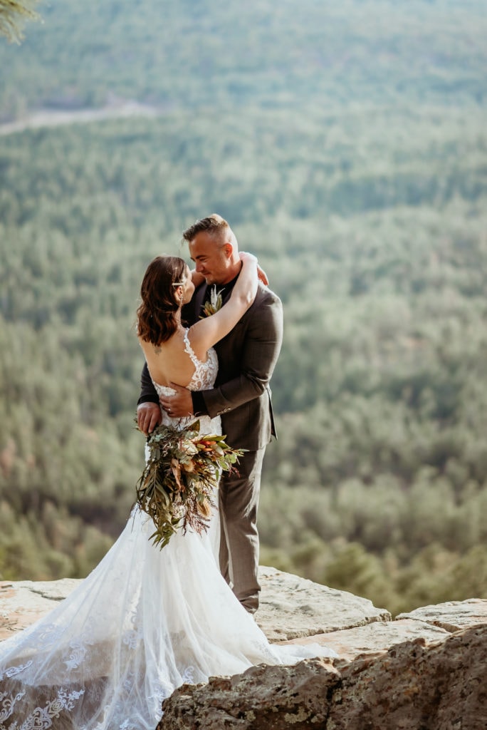 Bride and groom slow dancing as they stand at the edge of the Mogollon Rim in Arizona