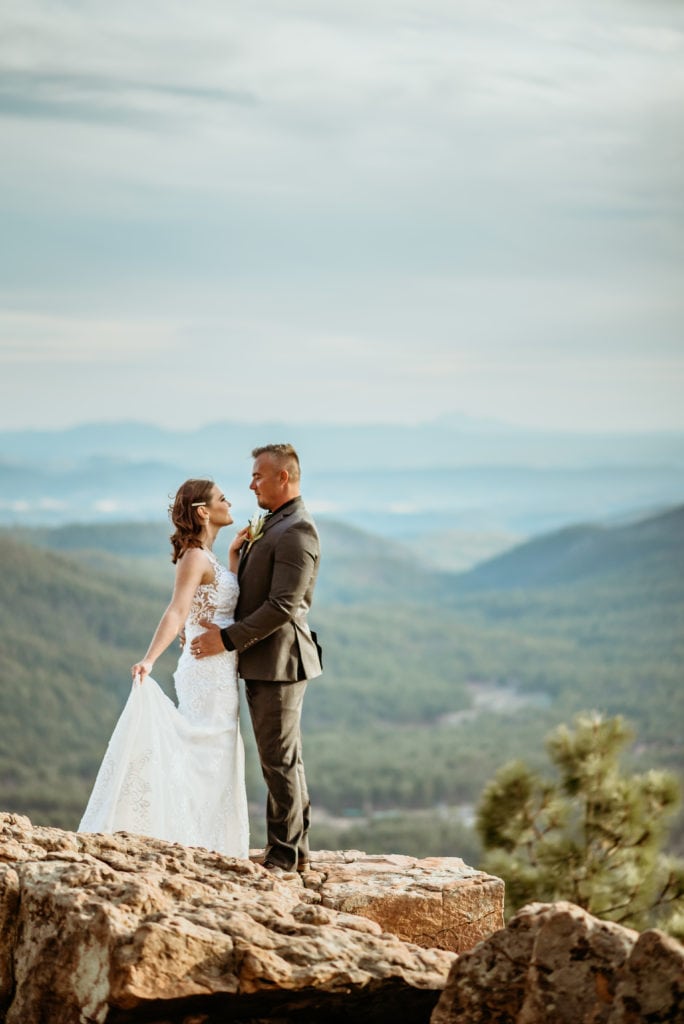 The sky is the limit as sweet bride and groom embrace on the edge of a Mogollon Rim cliff
