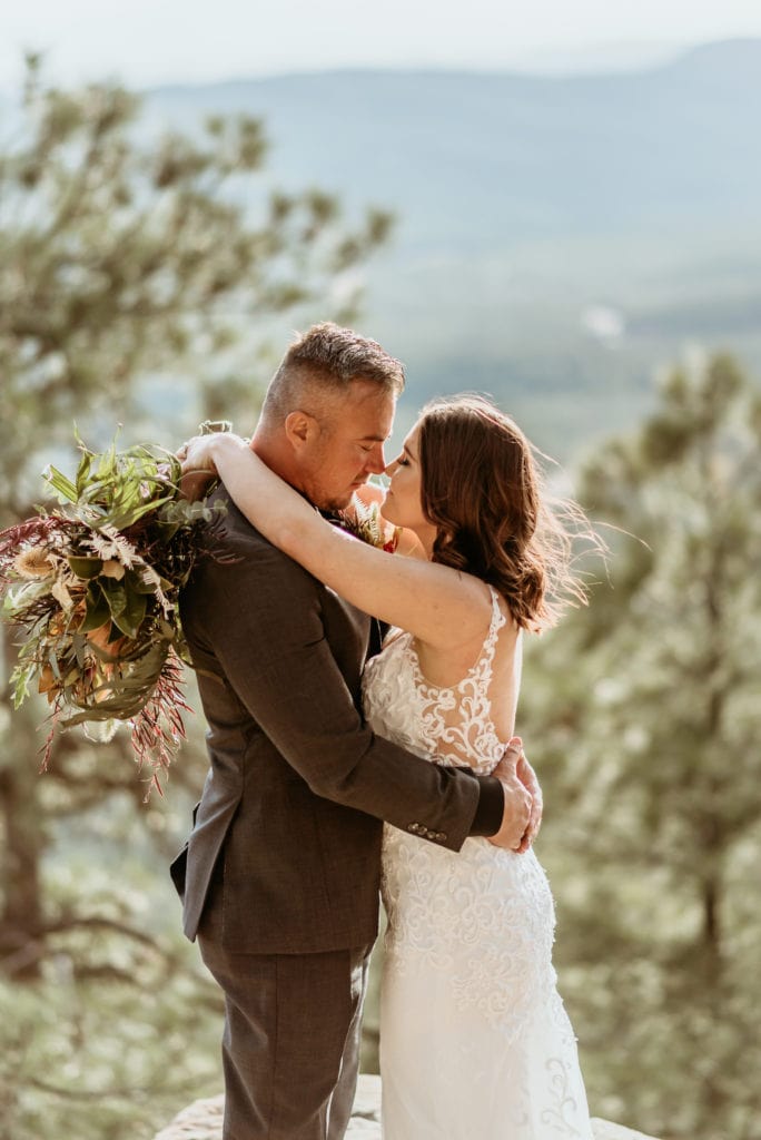 Bride and groom standing on a ledge on the Mogollon Rim
