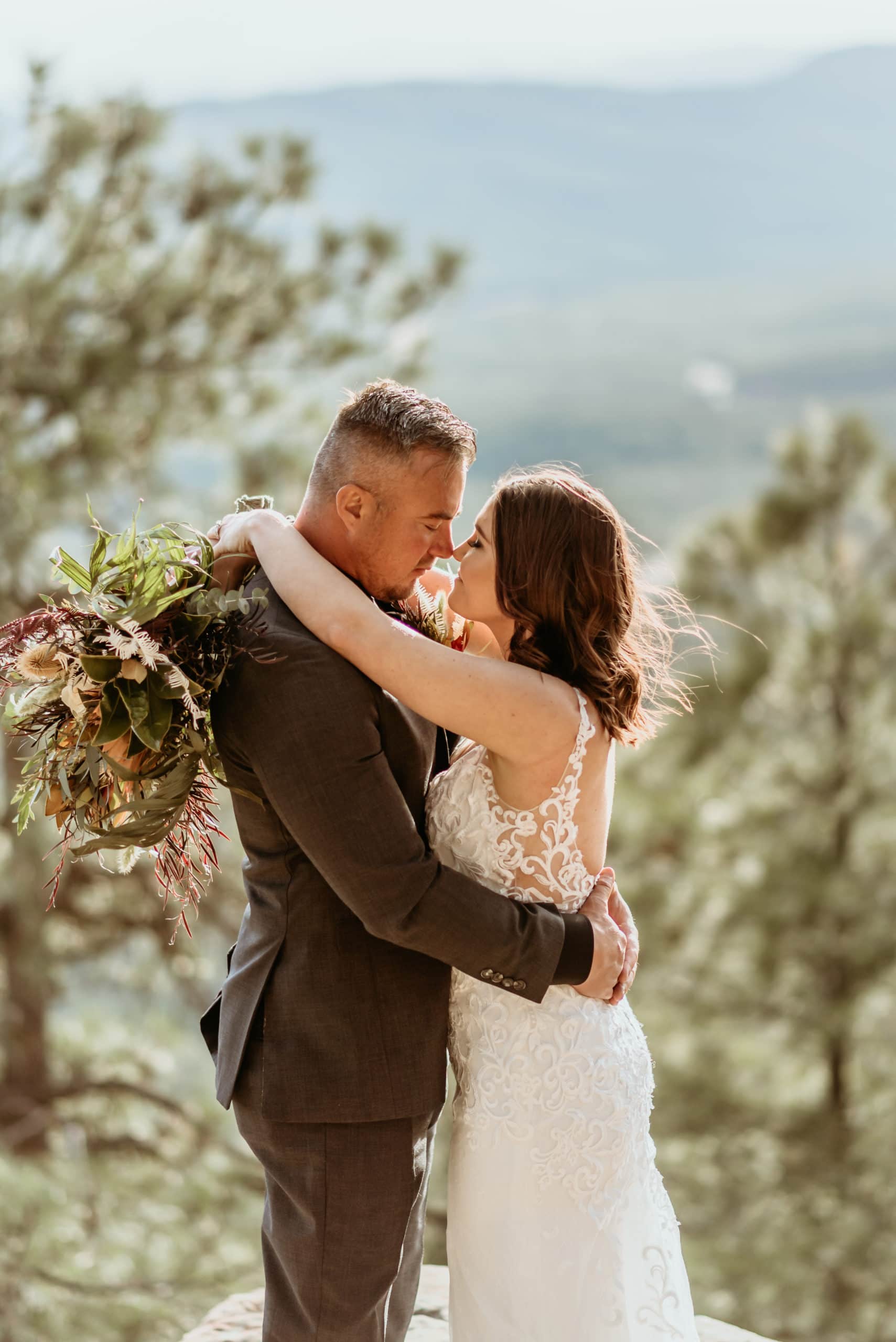 Bride and groom standing on a ledge on the Mogollon Rim
