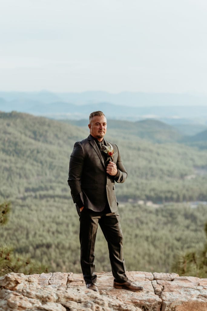 Groom in all black wedding suit