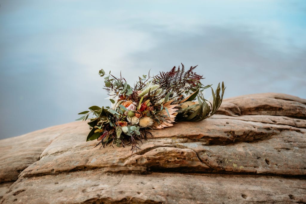 Boho bouquet laid on a rock during a winter elopement in Arizona