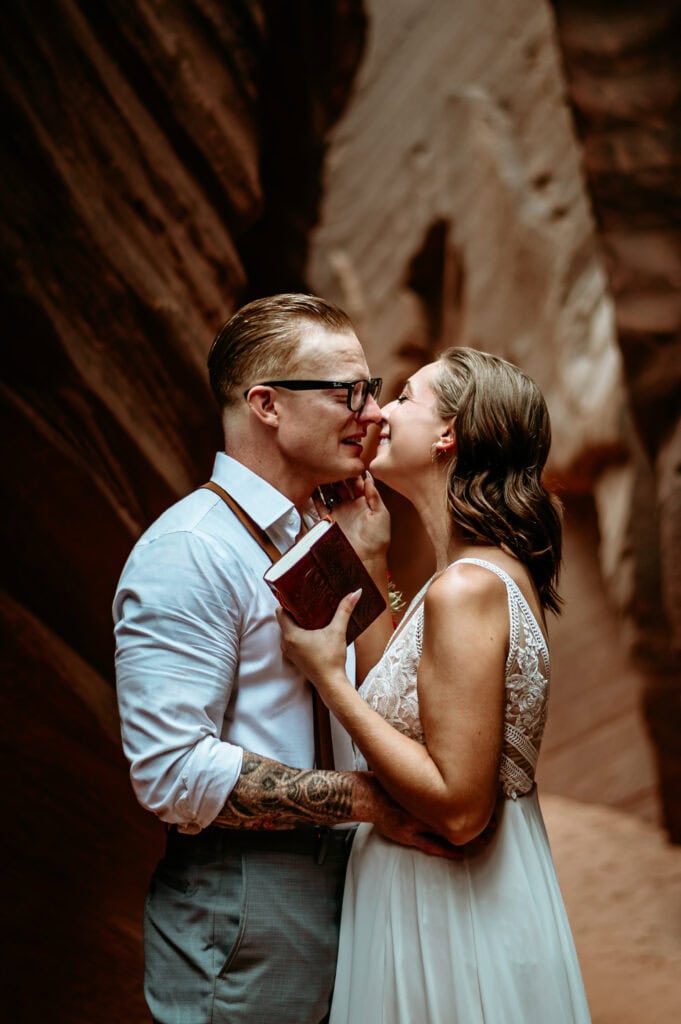 Emotions run high during slot canyon private vow reading Arizona elopement by Stratus Photography