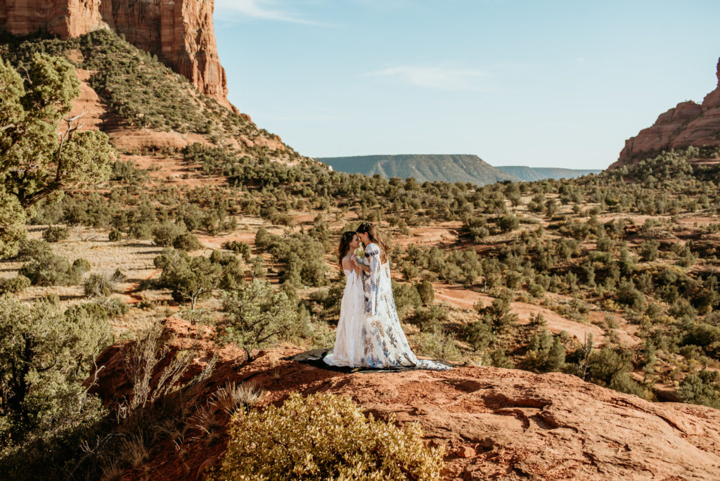 Two brides standing at a gorgeous Sedona overlook