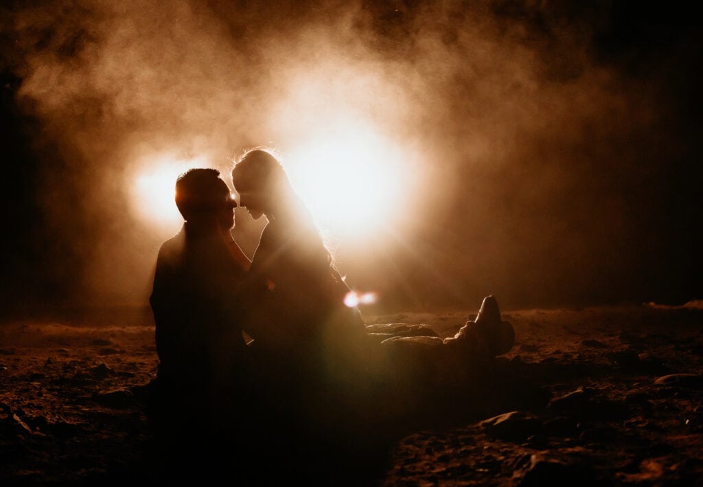 Couple silhouetted by vehicle headlights during Sedona couple's session