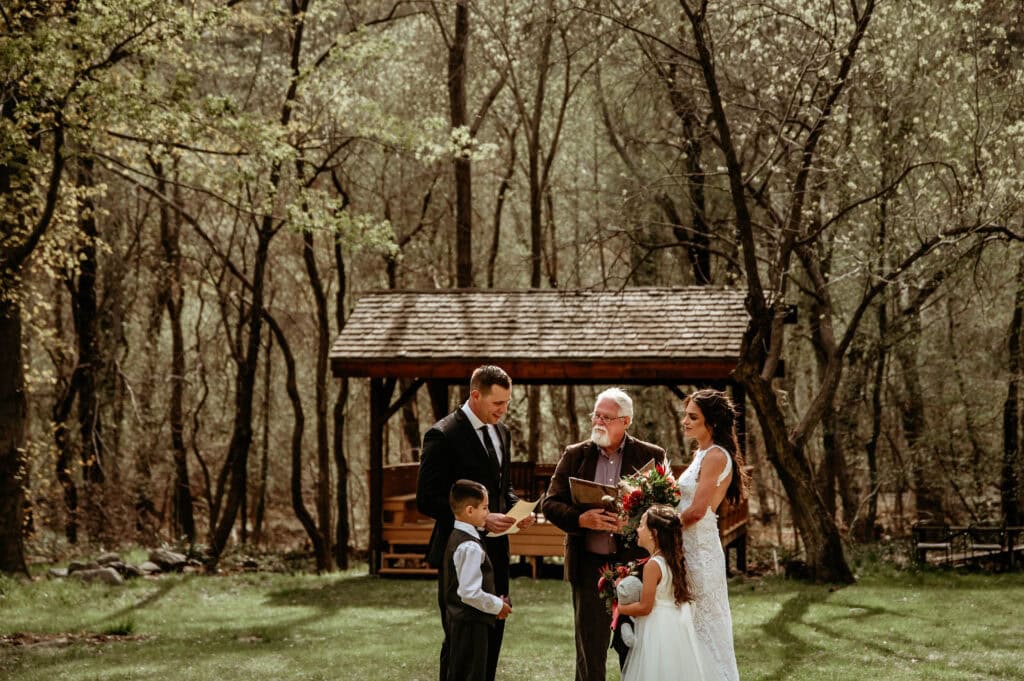 groom reads a letter to wife and children during their intimate elopement