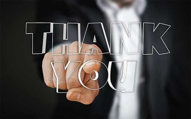 someone pointing with the words thank you in the foreground