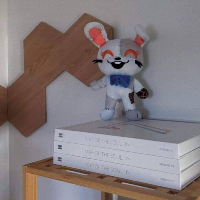 "9-inch Youtooz Five Nights at Freddy's Vanny Chibi plush with grey patchwork design, dark blue bow, and bright red eyes."