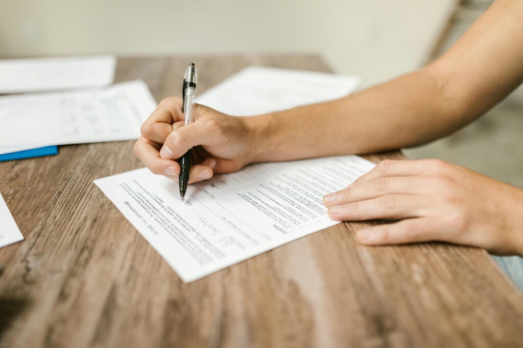 Person filling out a scorecard at a desk.