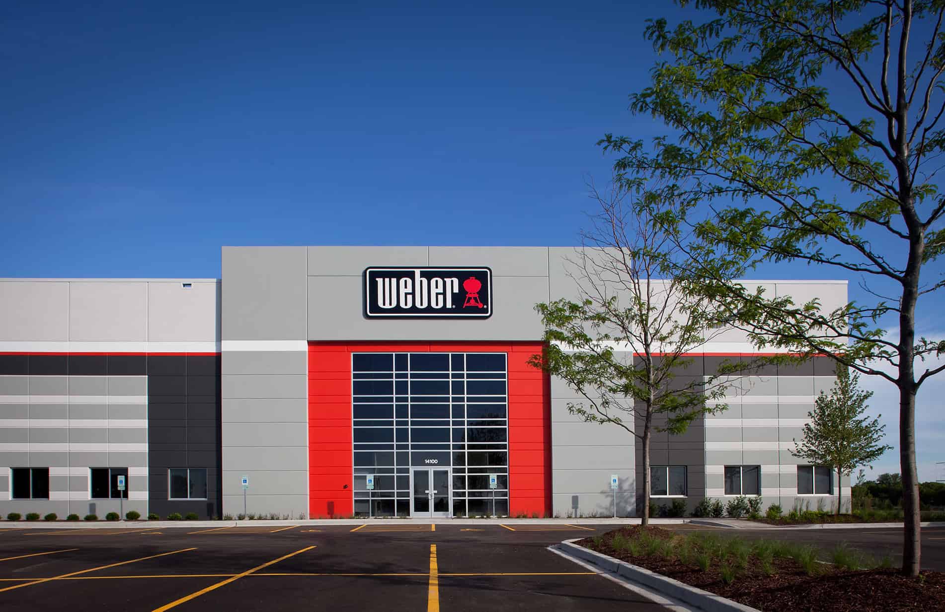 The Weber-Stephen facility as seen from the parking lot. The front entrance is clear and the sign above says "Weber."