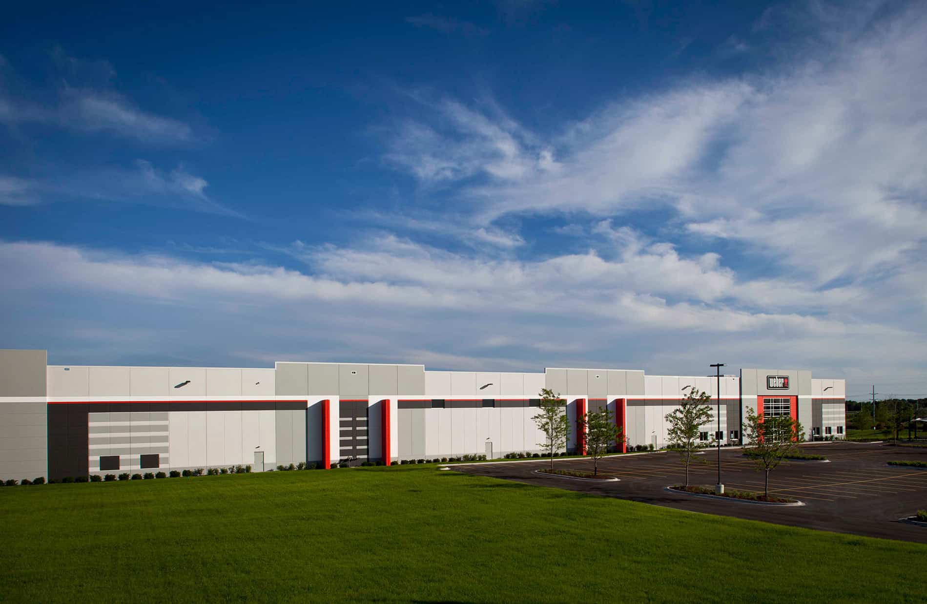 Under a blue sky sits a large, newly constructed distribution facility for Weber-Stephen. Keeley Construction, Inc. was responsible for the 750,000 SF space.