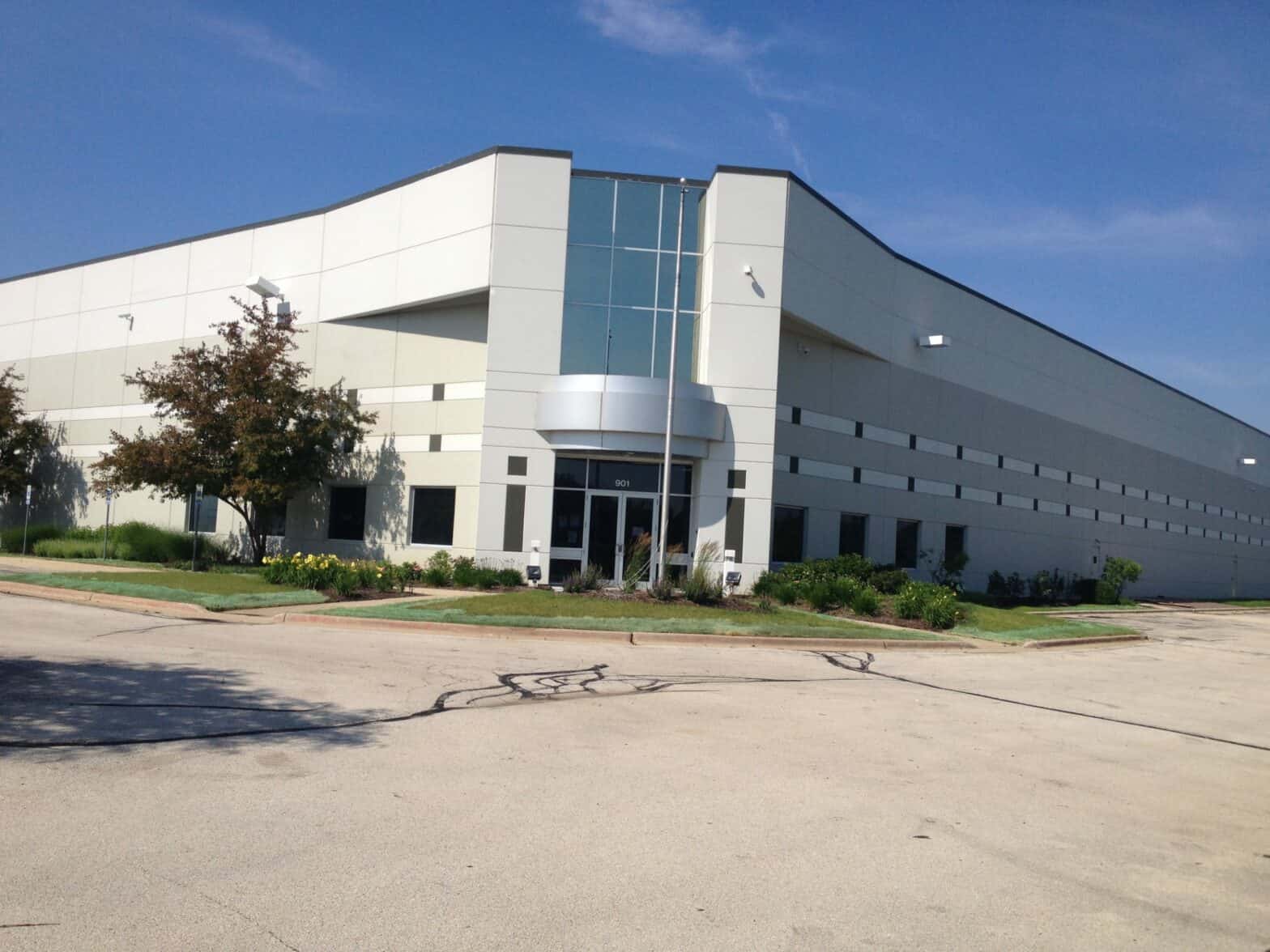 The Ferrara Candy Company's building stands against a blue sky and has an entrance area in the corner of the headquarters.