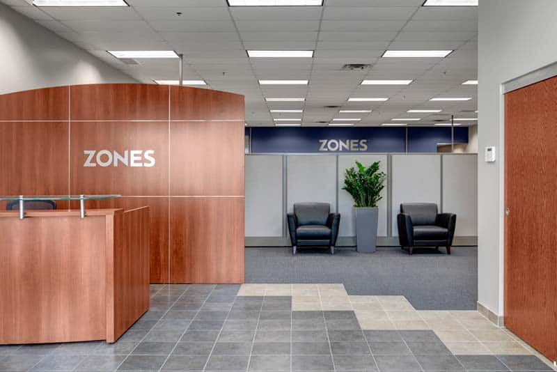 The lobby of a new office building. The sign behind reception says, "Zones." Keeley Construction handled the renovation and construction of this facility.