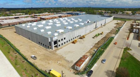 An aerial view of a large, newly constructed industrial building made by Keeley Constructions, Inc.
