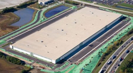 A bird’s eye view of M Block & Sons' new building is a large rectangle surrounded by re-graded landscapes, parking lots, and ponds.
