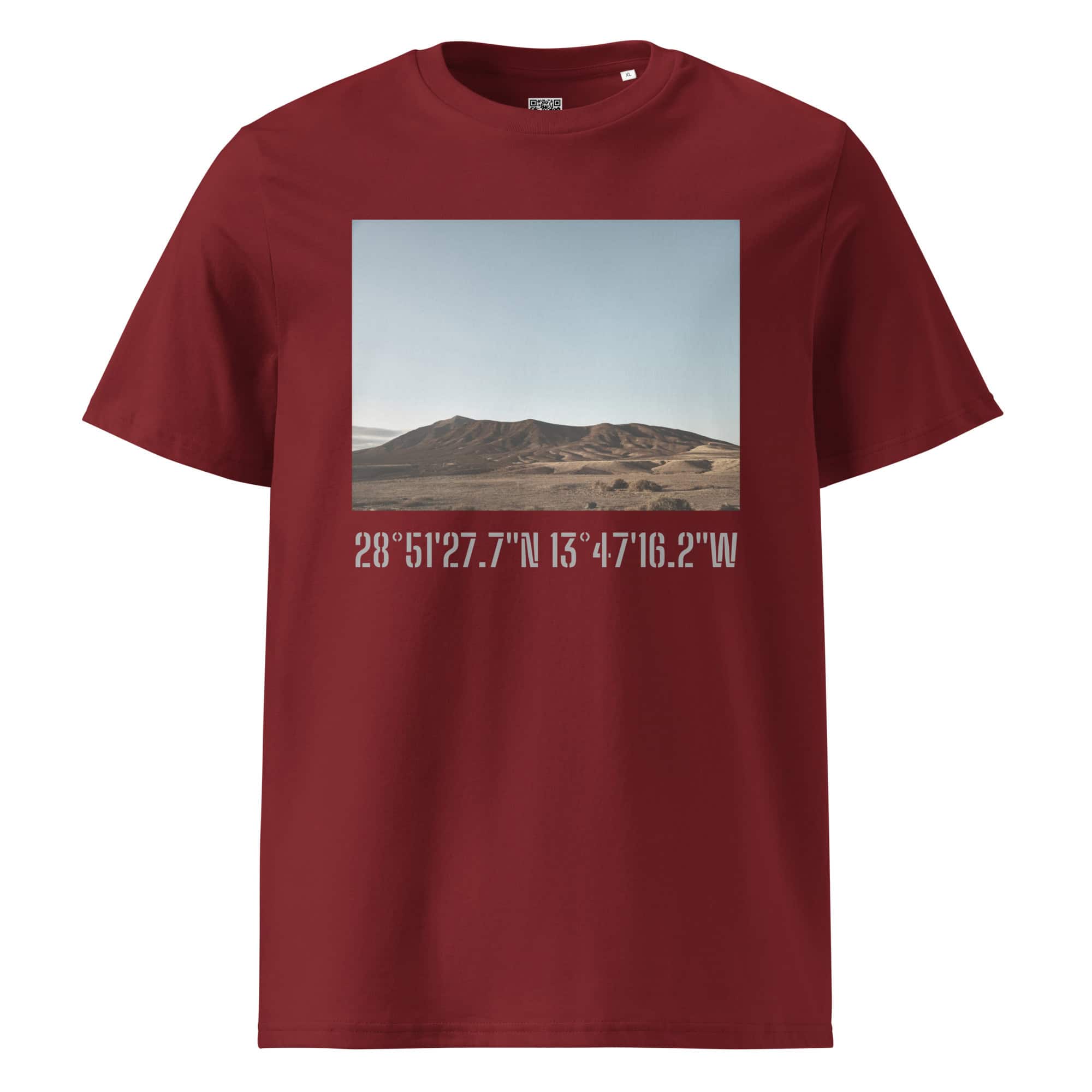 Nuestra Tienda Online ofrece la Camiseta unisex Los Ajaches, una camiseta de color granate que muestra la imagen de un paisaje desértico con colinas bajo un cielo despejado. Debajo de esta llamativa obra de arte, se muestran con elegancia las coordenadas blancas 28°5127.7N 13°4716.2W, que combinan moda y arte decorativo sin esfuerzo.