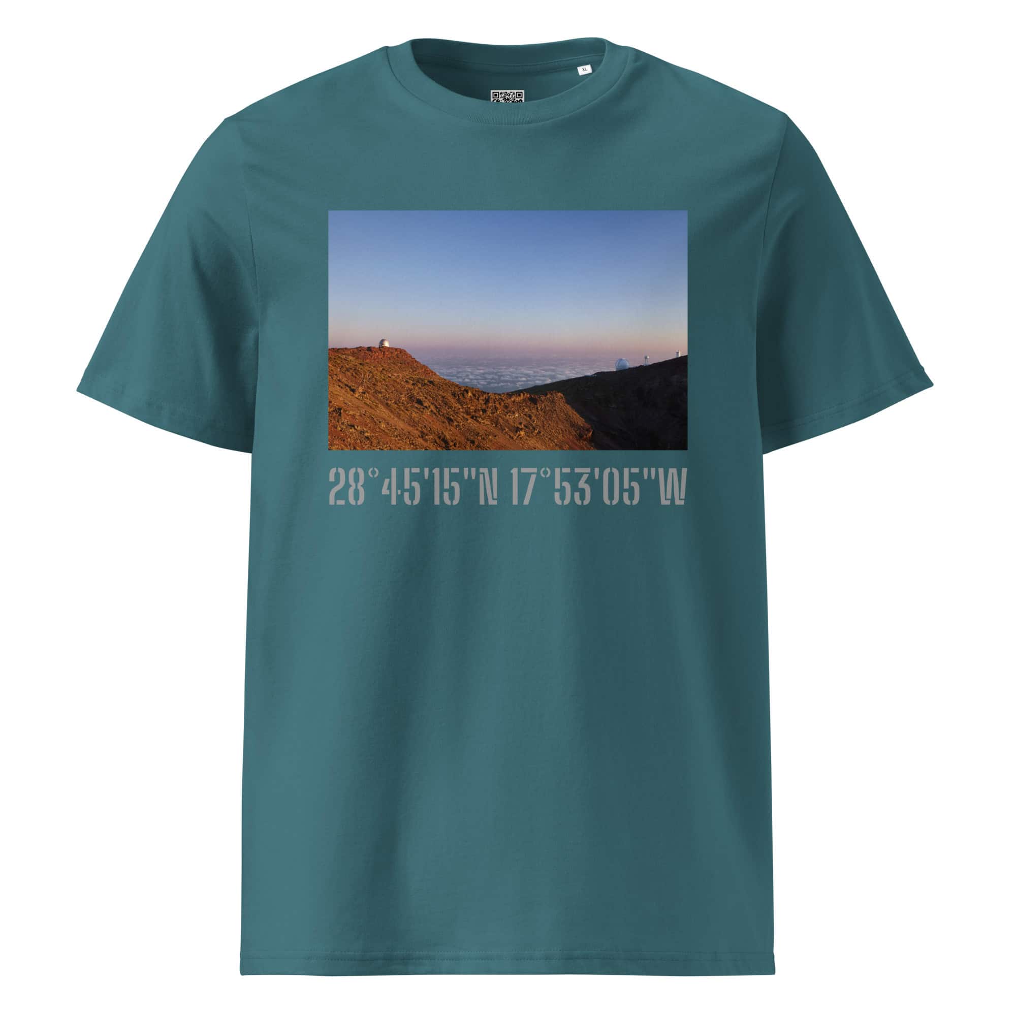 Una camiseta verde azulado con una impresionante fotografía del paisaje montañoso de La Palma al atardecer, con una persona de pie triunfante en la cima. Debajo de esta impresionante escena de Paisajes Canarios se muestran las coordenadas: 28°4515N 17°5305W, disponible como Camiseta unisex Telescopios del Roque de los Muchachos.