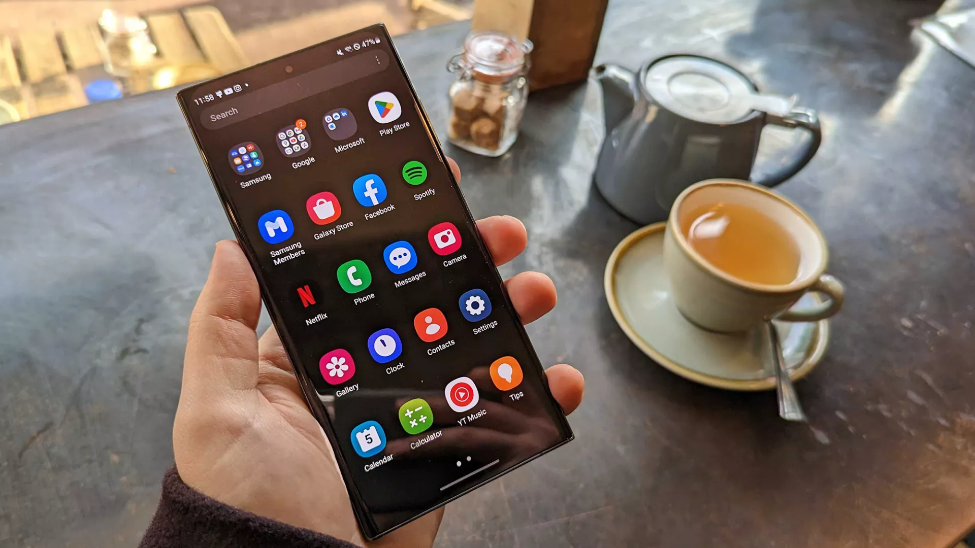 A Person Holding An Android Phone, Depicting The Potential Issue Of Accidental Emergency Calls.