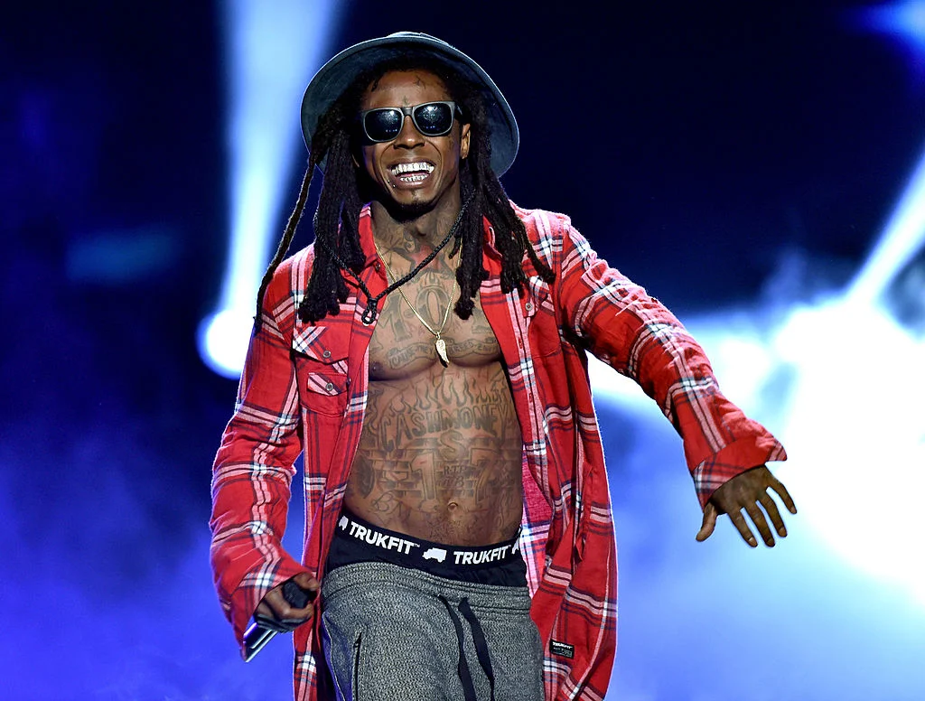 Image Of Lil Wayne Performing On Stage, Representing His Musical Success And Career.