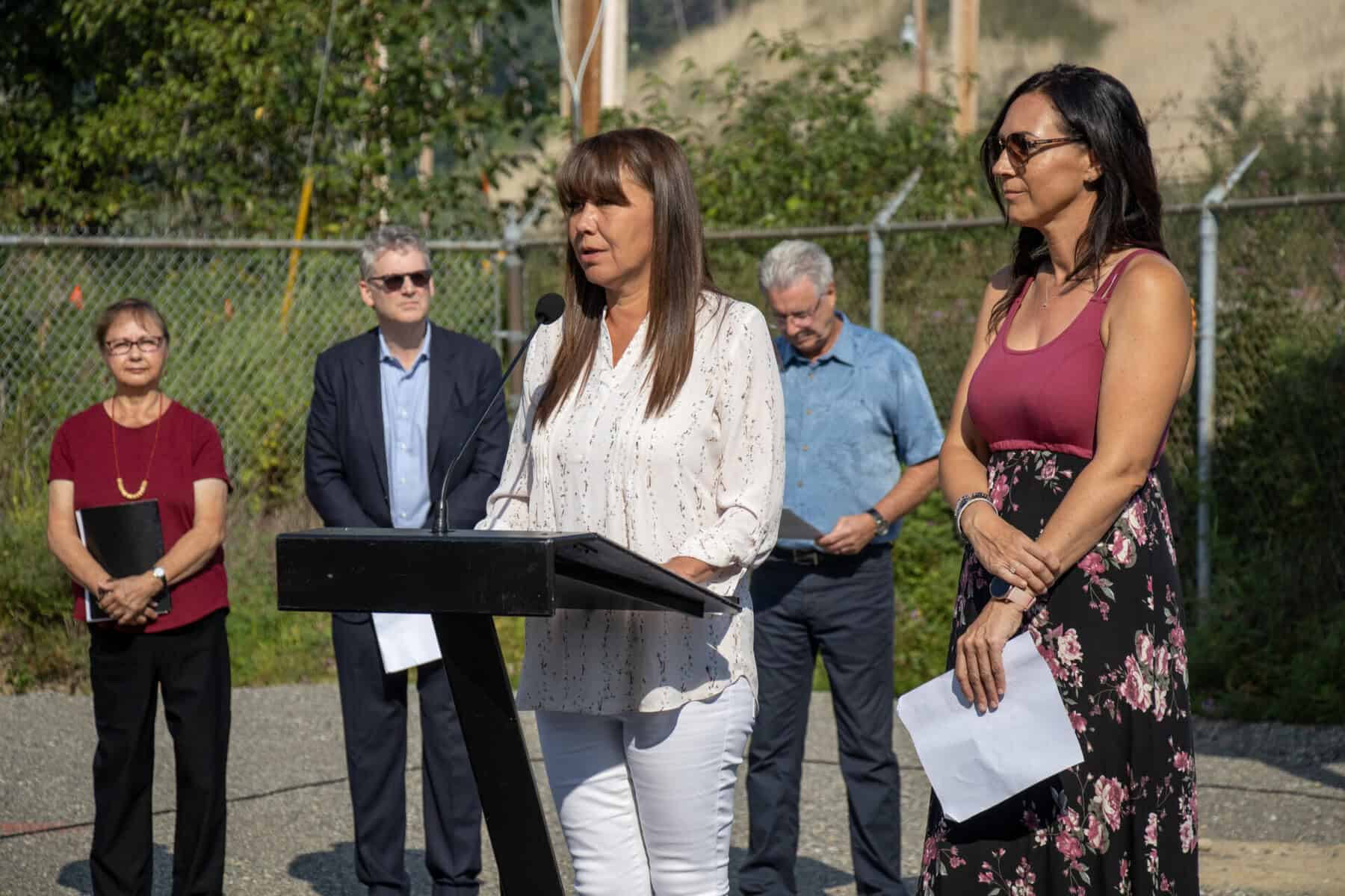 Members of the Arbios team and Lheidli T’enneh First Nation name the facility Chuntoh Ghuna on a microphone and podium