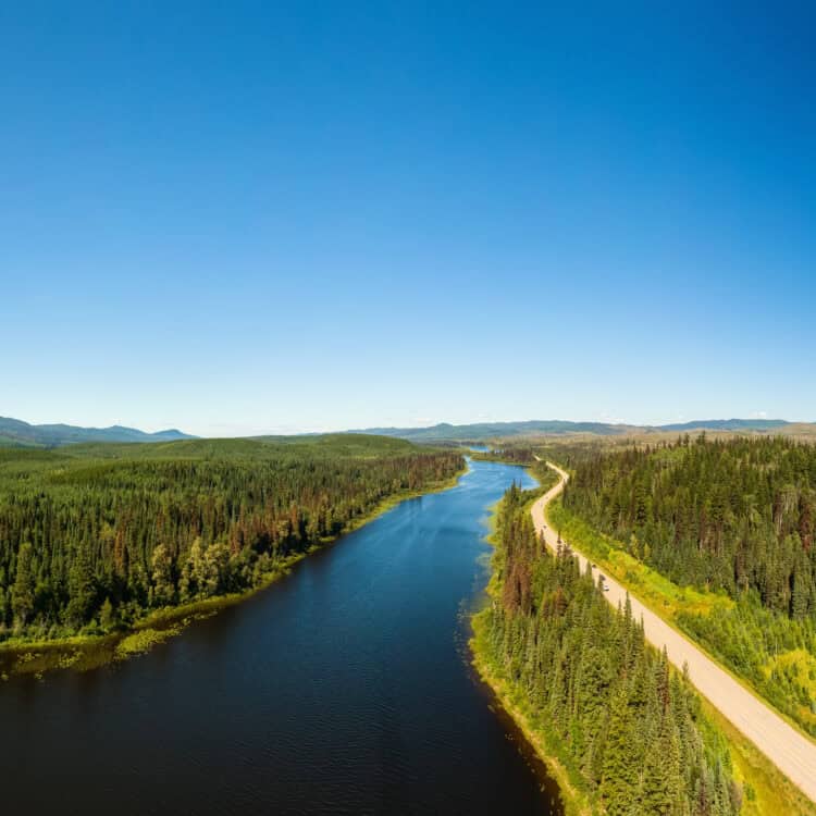 Scenic Panoramic Lake View of Curvy Road in Canadian Nature on a Sunny Summer Day. North of Prince George, John-Hart Highway, British Columbia.