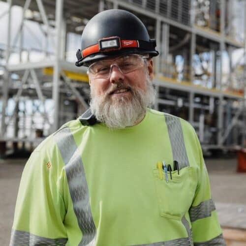 a man wearing a helmet and a green shirt