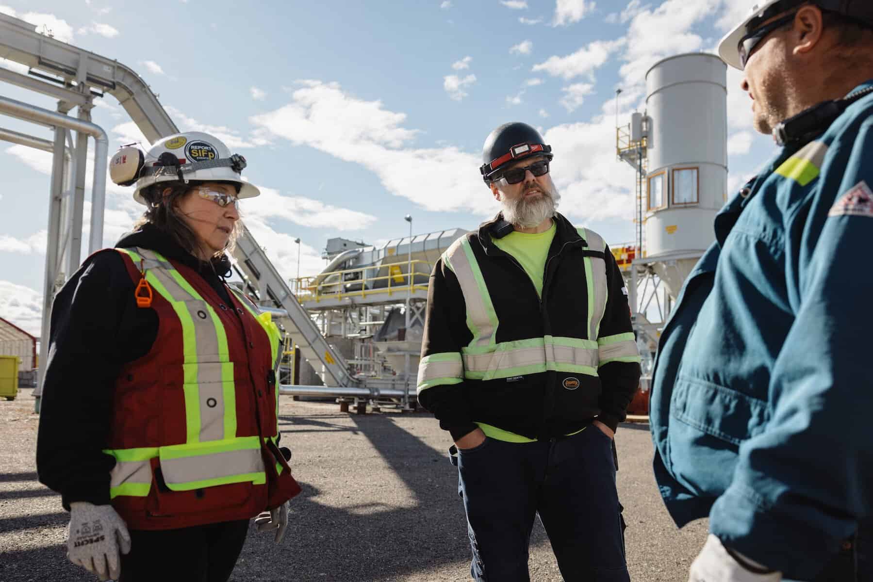 Three Arbios facility workers discussing at the Chuntoh Ghuna plant