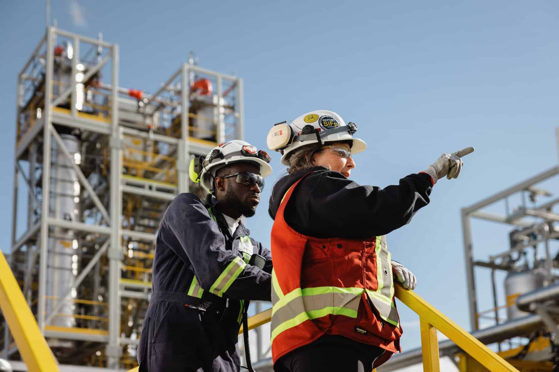 a group of people wearing safety gear and pointing off camera